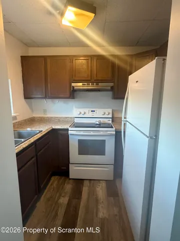 a kitchen with a sink and a refrigerator