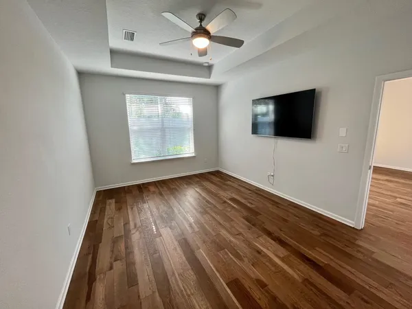 wooden floor in an empty room with a window