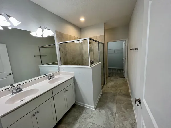 a bathroom with a double vanity sink and a mirror