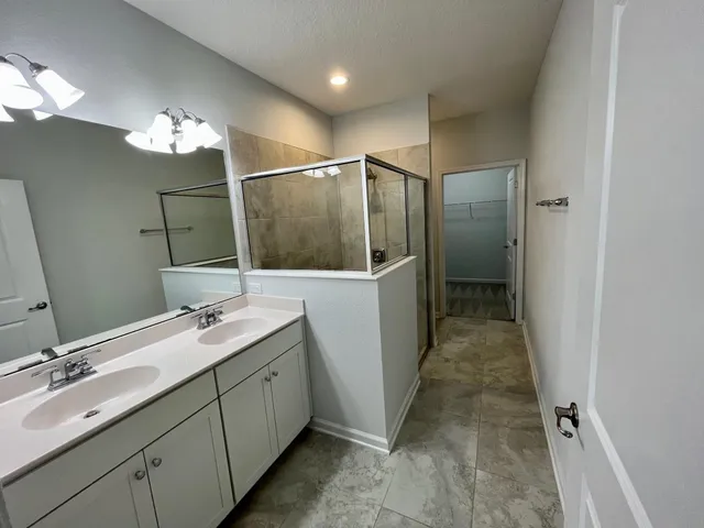 a bathroom with a double vanity sink and a mirror
