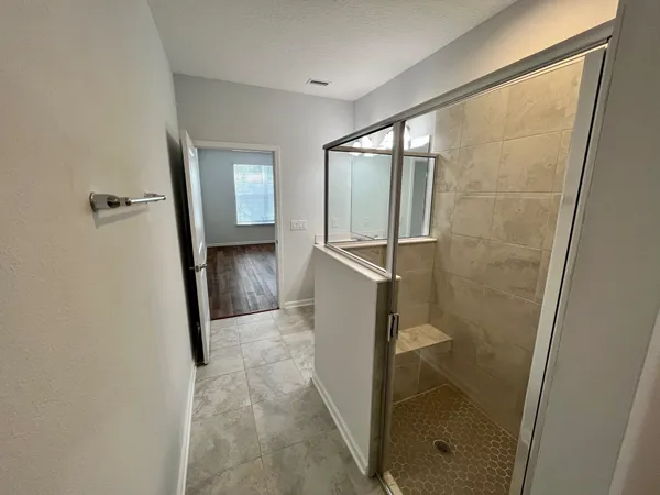 a bathroom with a shower and a sink