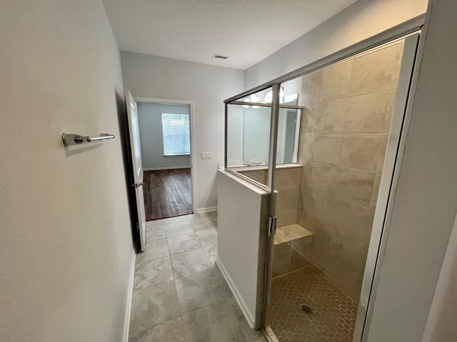 a bathroom with a shower and a sink