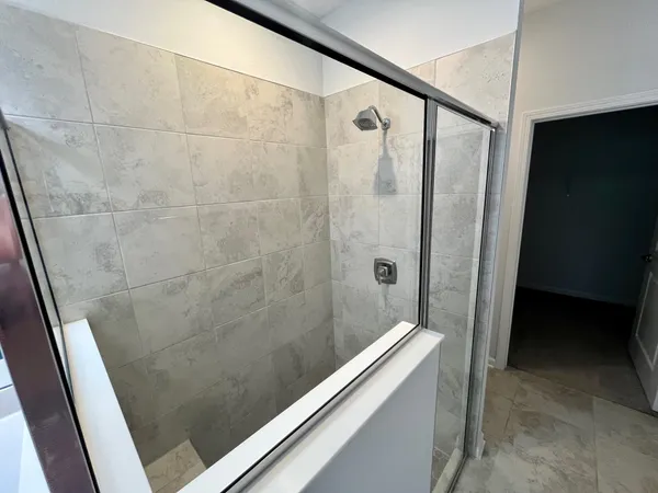a bathroom with a shower and a sink