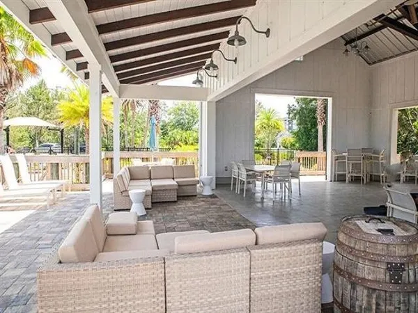 a living room with fireplace furniture and a large window