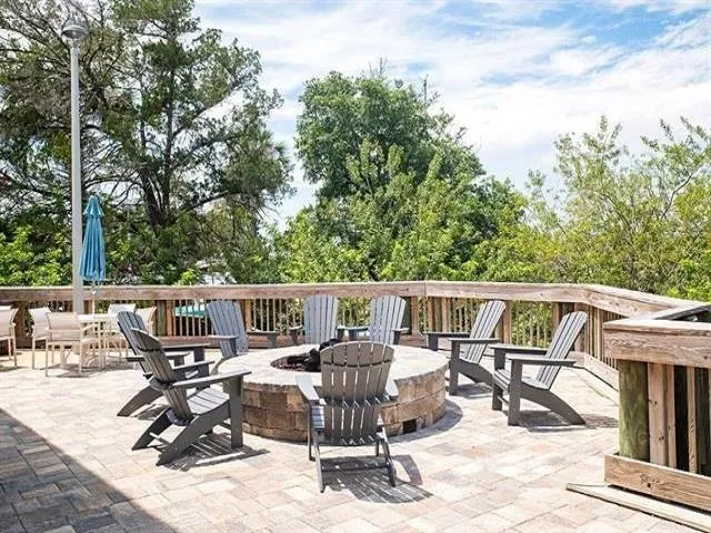 a view of a patio with table and chairs and wooden floor