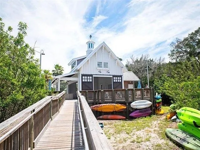 a view of a house with swimming pool and furniture