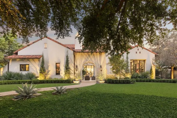 a front view of house with a garden