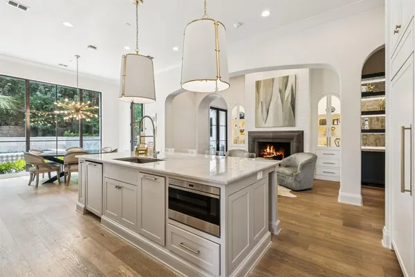 a kitchen with stainless steel appliances granite countertop a stove and a wooden floor