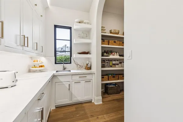 a kitchen with a sink cabinets and window