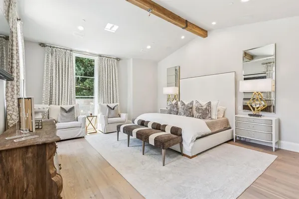 a spacious bedroom with a bed and a couch