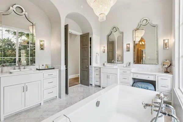 a spacious bathroom with a granite countertop sink a mirror and a vanity