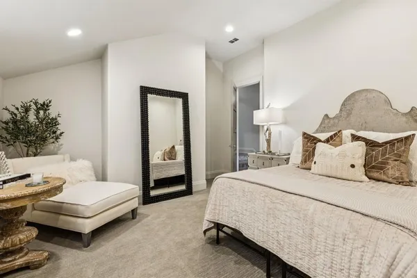 a spacious bedroom with a bed and a couch