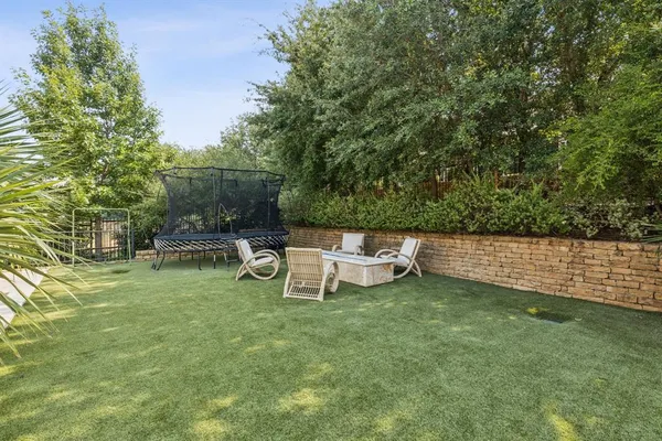 a view of a chair and table in the garden