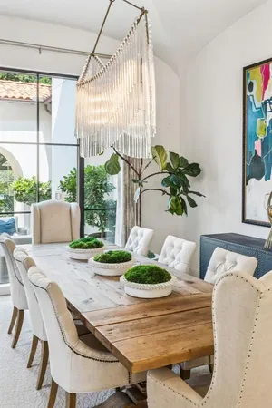 a dining room with furniture and wooden floor to ceiling window