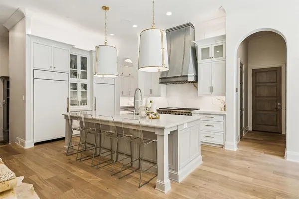 a kitchen with stainless steel appliances granite countertop a stove a refrigerator and a microwave