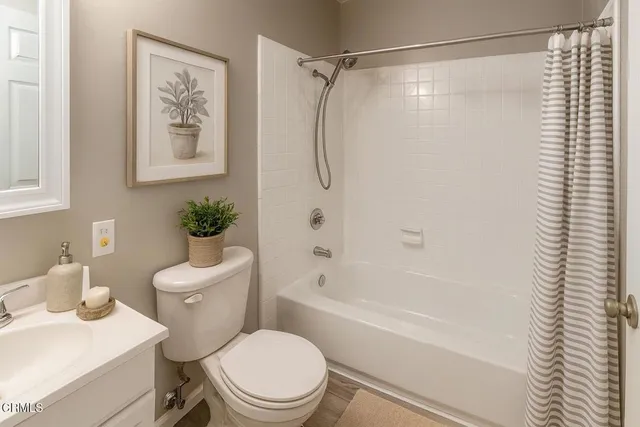 a white toilet sitting next to a bath tub shower