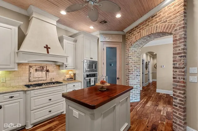 a kitchen with sink stove and cabinets