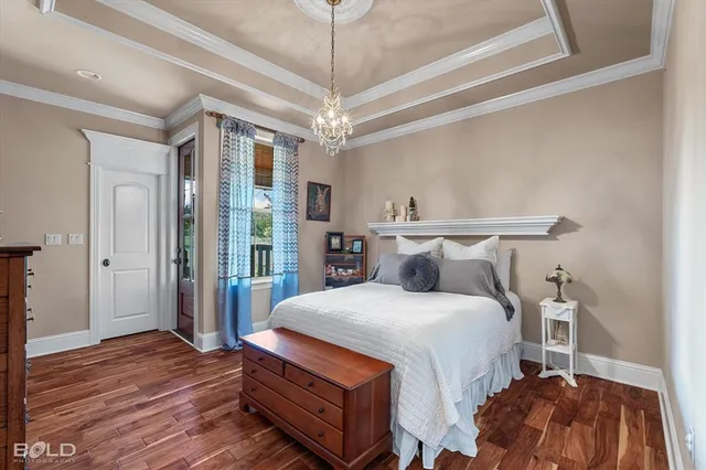 a bedroom with bed and wooden floor
