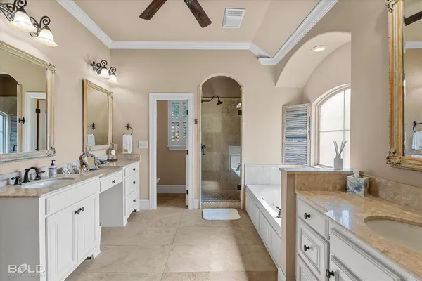 a spacious bathroom with a granite countertop sink mirror and bathtub