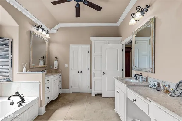 a spacious bathroom with a double vanity sink a mirror and shower