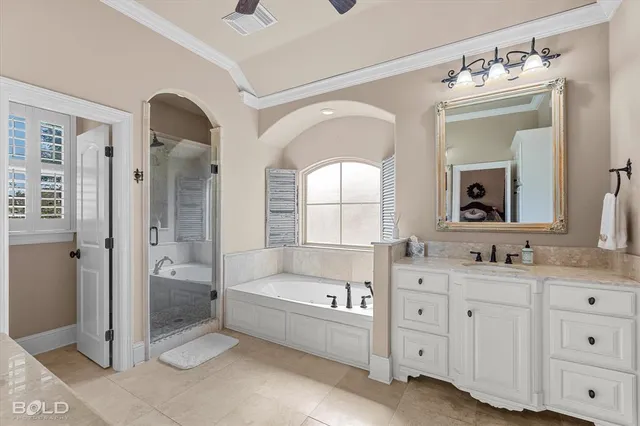 a bathroom with a double vanity sink mirror and bathtub