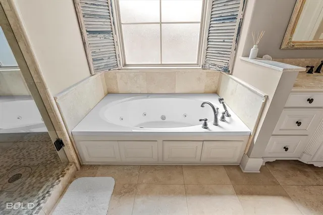 a bathroom with a bathtub and a window