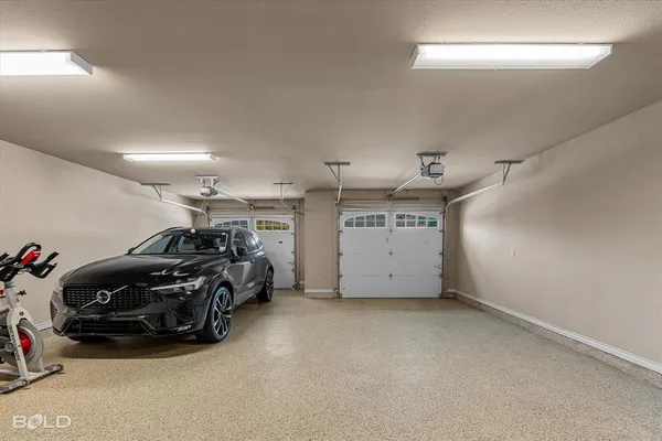a view of a garage with furniture and cars