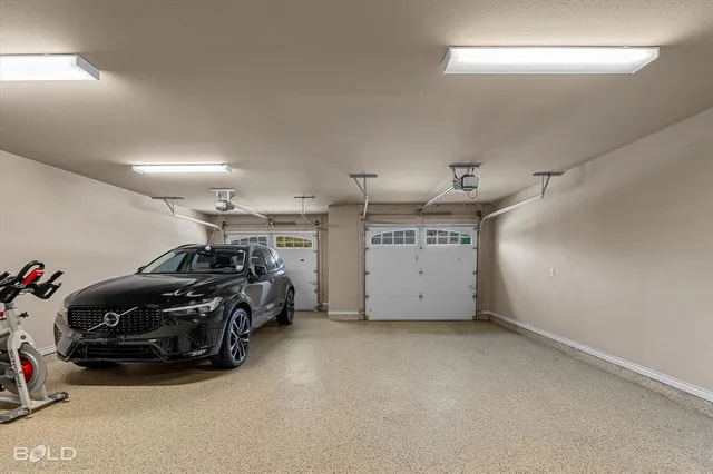 a view of a garage with furniture and cars