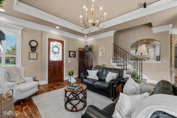 a living room with furniture and a chandelier