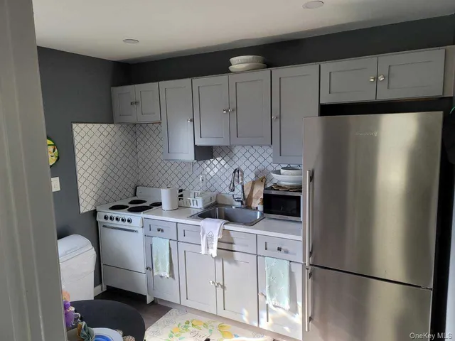 a kitchen with stainless steel appliances a refrigerator sink and cabinets