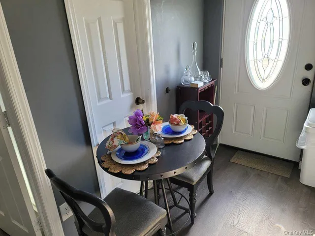 a view of a dining room with furniture and chandelier