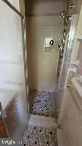 a bathroom with a toilet and a shower curtain