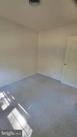 a bedroom with a bed and a lamp on desk