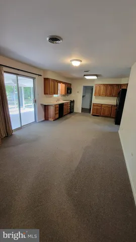 a view of empty room with a fireplace