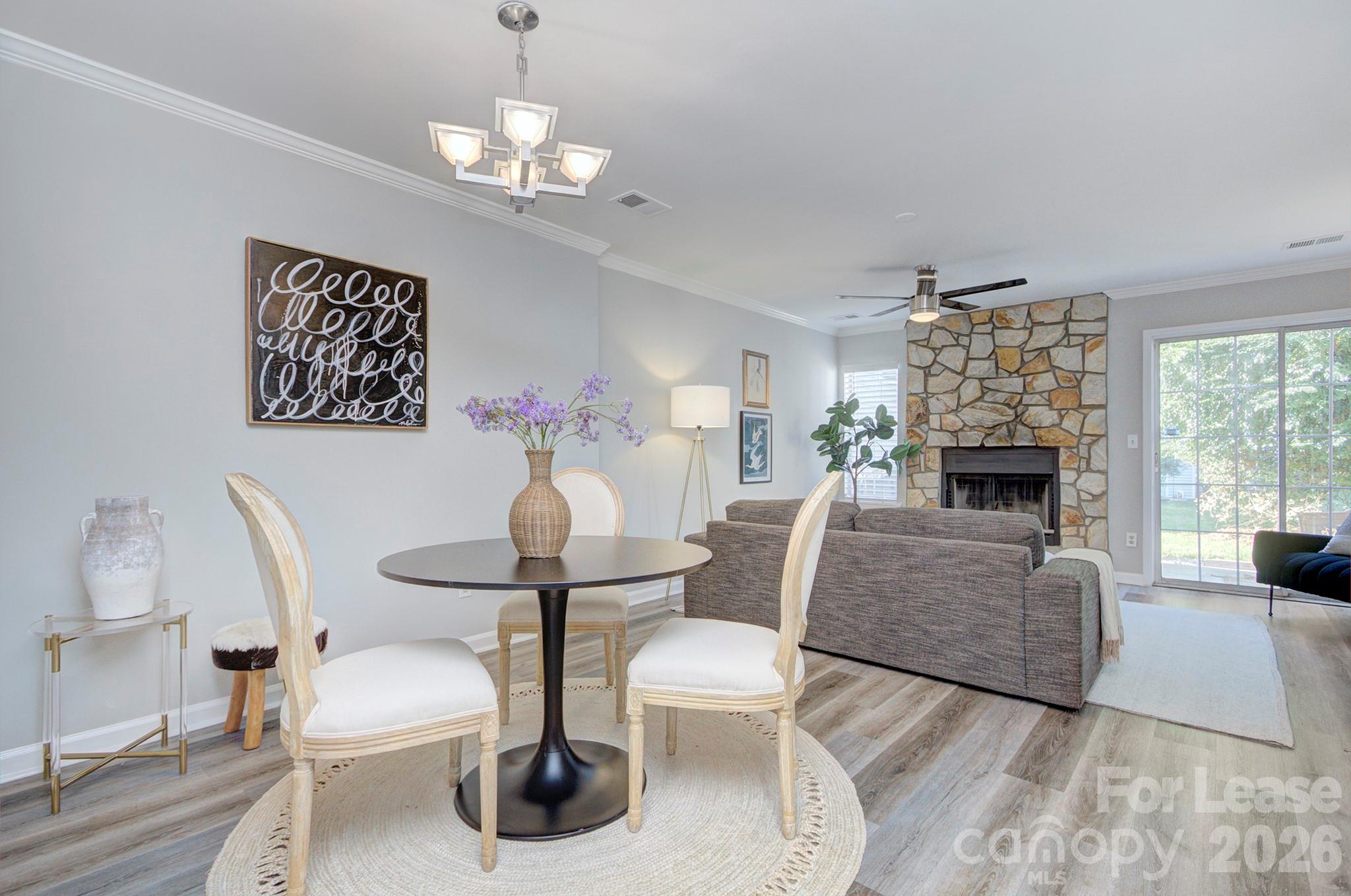 8268 Golf Ridge Drive Charlotte, NC 28277 - Photo 10 of 24 a living room with furniture a fireplace and a chandelier