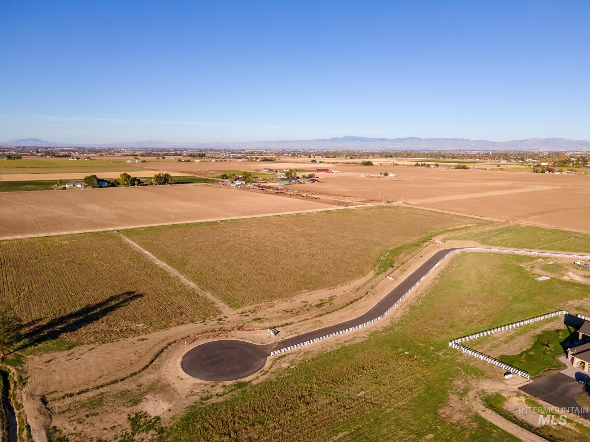 4276 West Mockingjay Kuna, ID 83634 - Photo 7 of 35 Aerial overview of property's location with rural landscape, mountains, and rows of crops