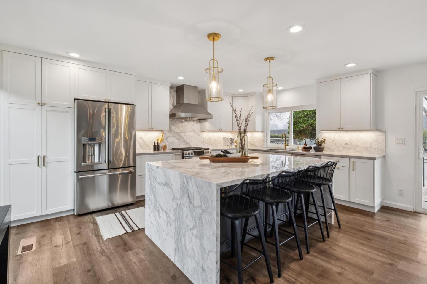 1962 Rancho Verde Circle West Danville, CA 94526 - Photo 21 of 60 a kitchen with stainless steel appliances kitchen island granite countertop a table chairs stove and refrigerator