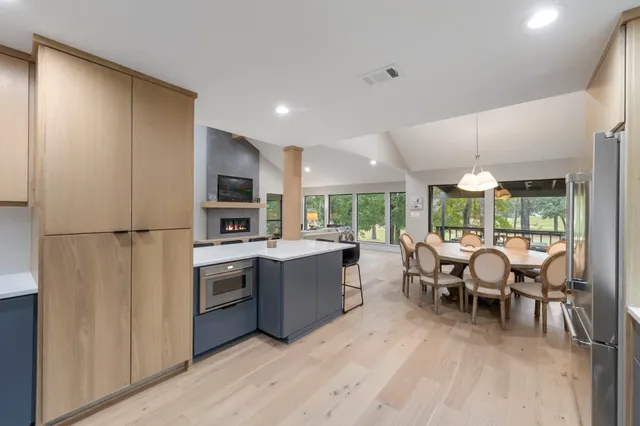 a kitchen with granite countertop a refrigerator and a sink