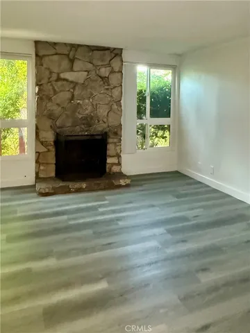 a living room with a fireplace and a large window