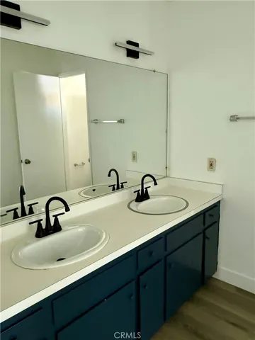 a bathroom with a double vanity sink and mirror