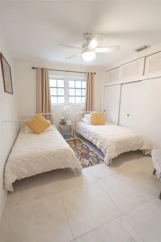 a bedroom with two beds and a chandelier