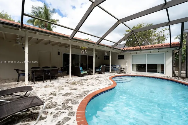 a view of swimming pool with outdoor seating