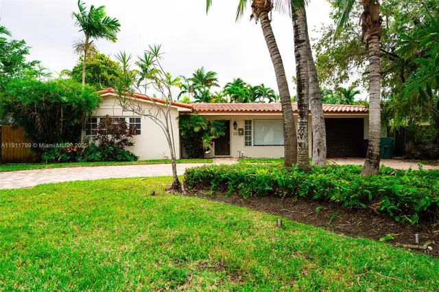 a front view of house with yard and green space