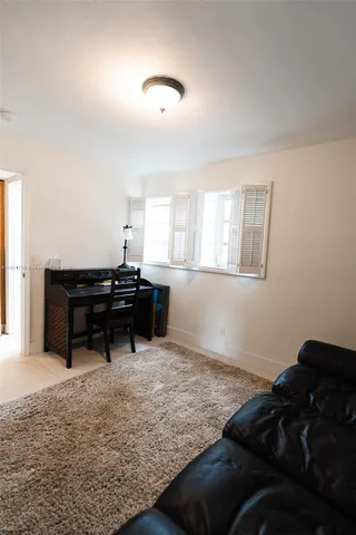 a living room with furniture and a piano