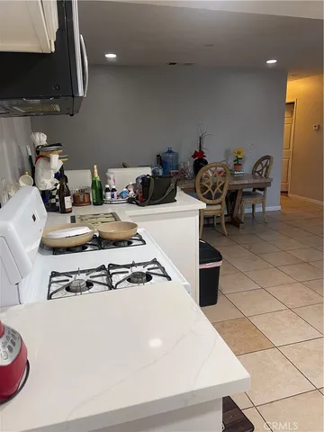 a kitchen with granite countertop stainless steel appliances and wooden cabinets