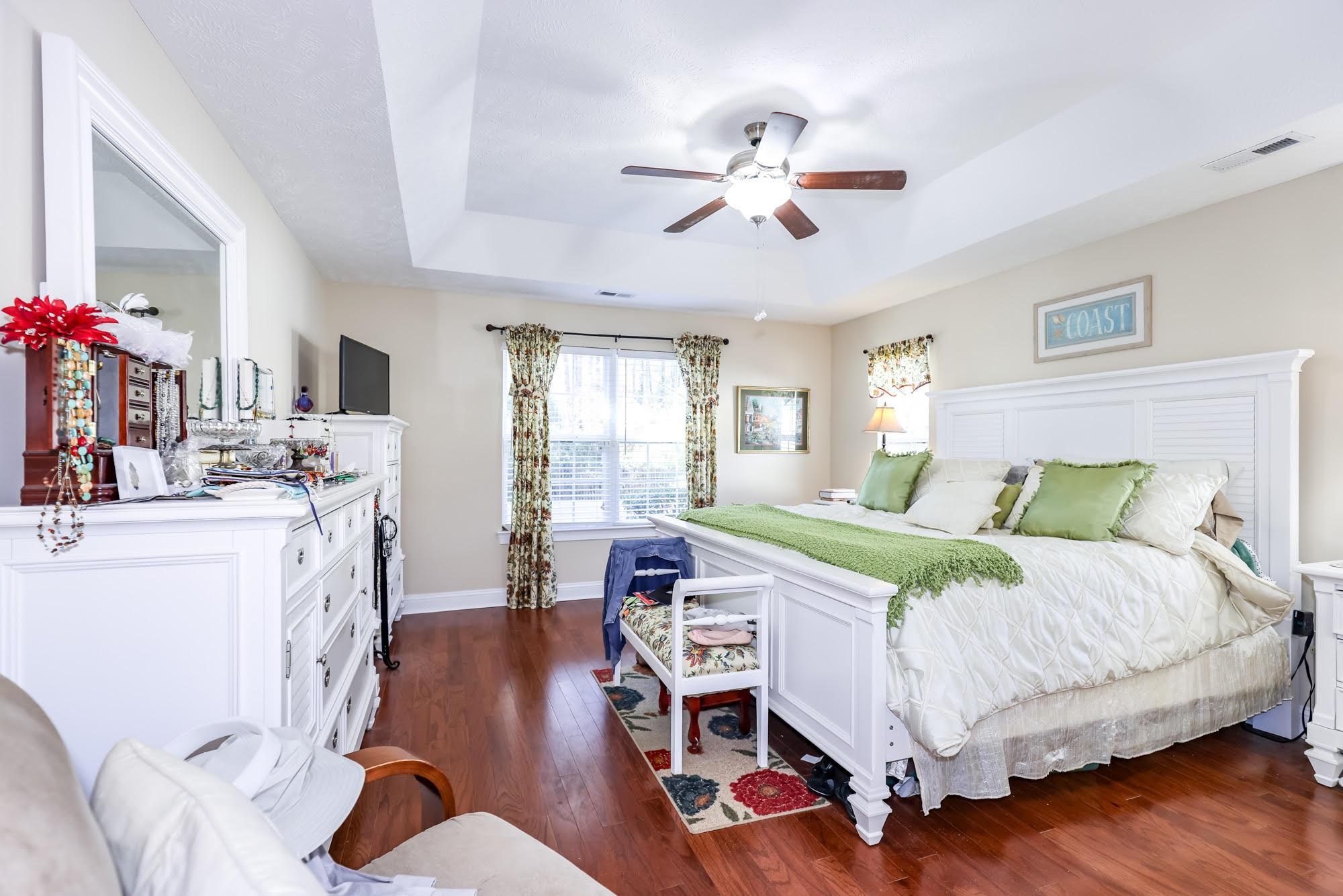 147 Quail Hollow Road Myrtle Beach, SC 29579 - Photo 11 of 35 Bedroom featuring a tray ceiling, dark wood-type flooring, and ceiling fan