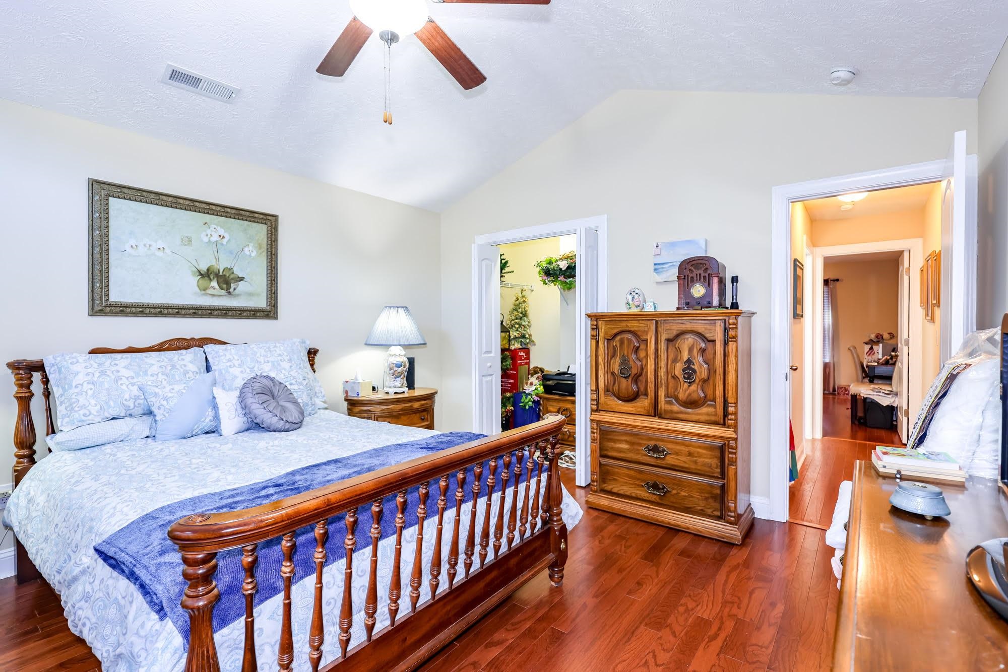 147 Quail Hollow Road Myrtle Beach, SC 29579 - Photo 19 of 35 Bedroom with a spacious closet, vaulted ceiling, dark wood-type flooring, and a ceiling fan