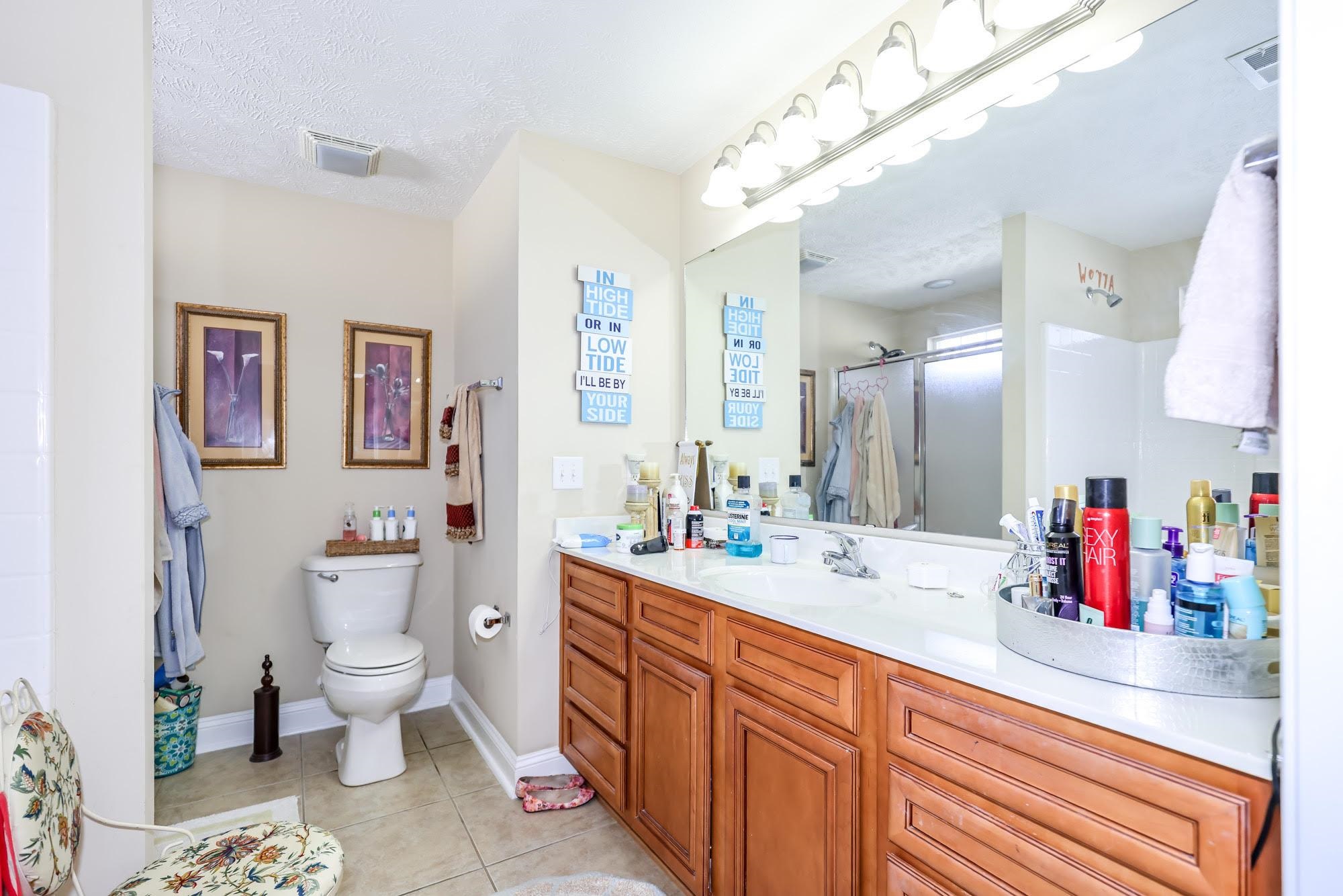147 Quail Hollow Road Myrtle Beach, SC 29579 - Photo 23 of 35 Full bath with vanity, a shower with shower curtain, light tile patterned floors, and a textured ceiling