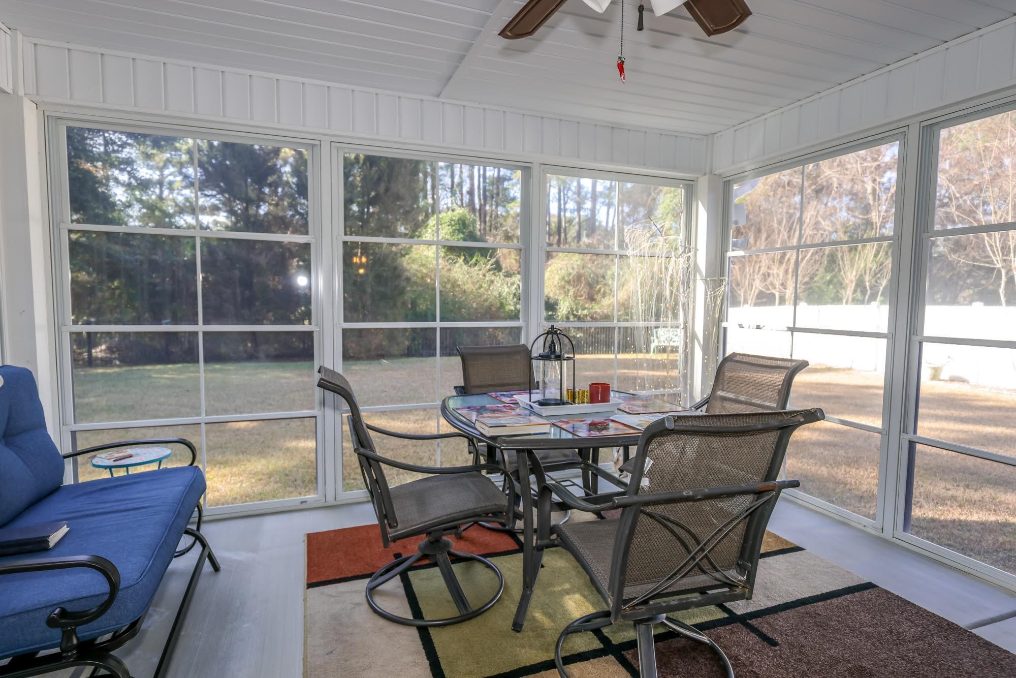 147 Quail Hollow Road Myrtle Beach, SC 29579 - Photo 27 of 35 Sunroom / solarium featuring ceiling fan and outdoor dining area