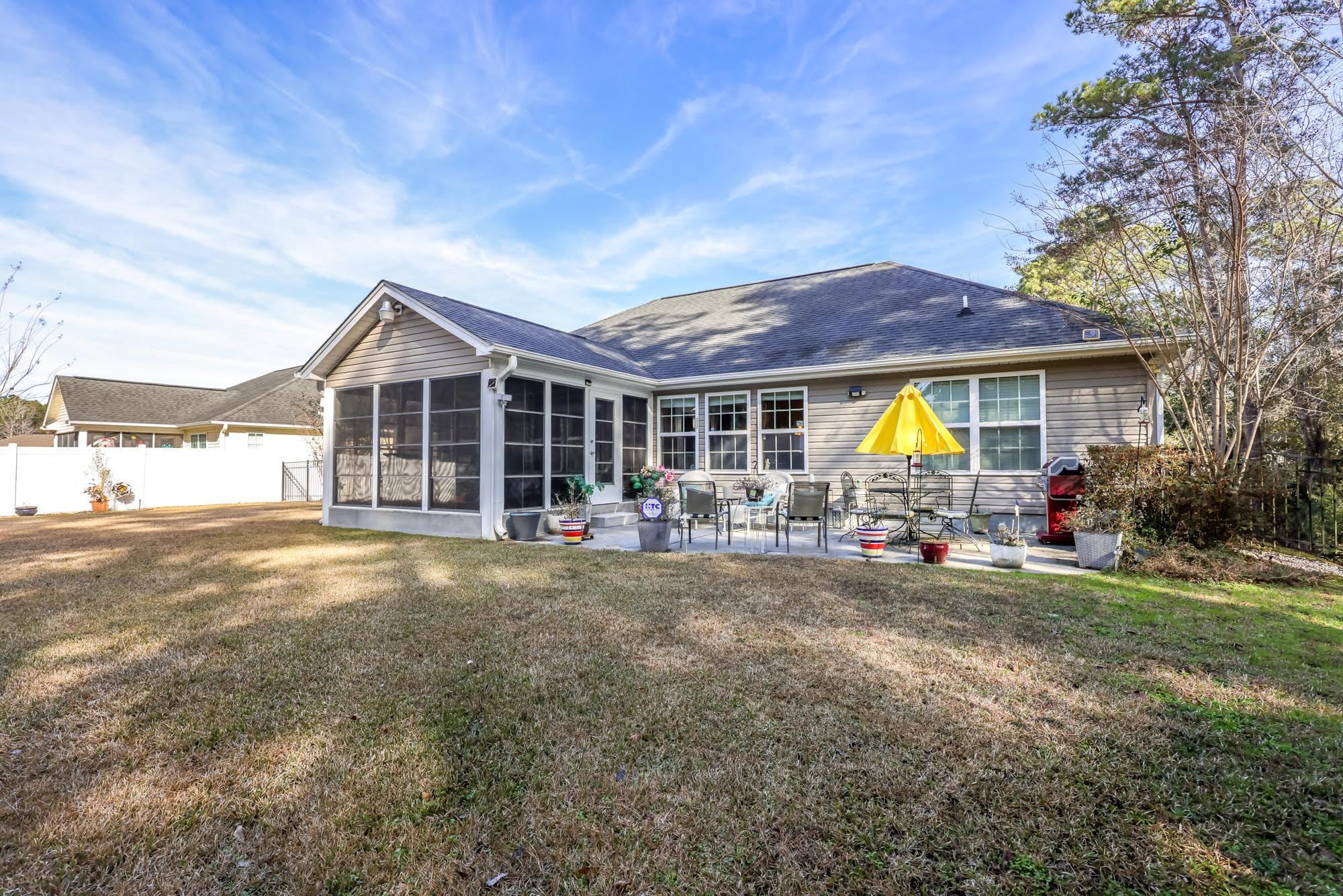 147 Quail Hollow Road Myrtle Beach, SC 29579 - Photo 30 of 35 Back of house with a fenced backyard and a sunroom